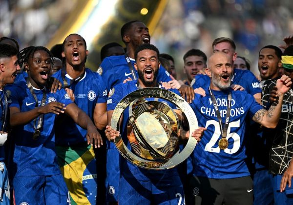 Jogadores do Chelsea comemoram a conquista do título da Copa do Mundo de Clubes com troféu em campo.